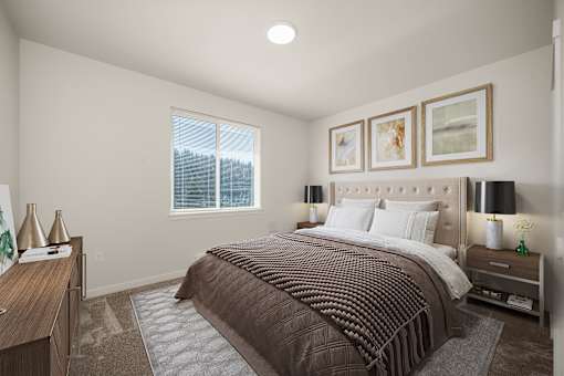 A bedroom with a large bed and a window.