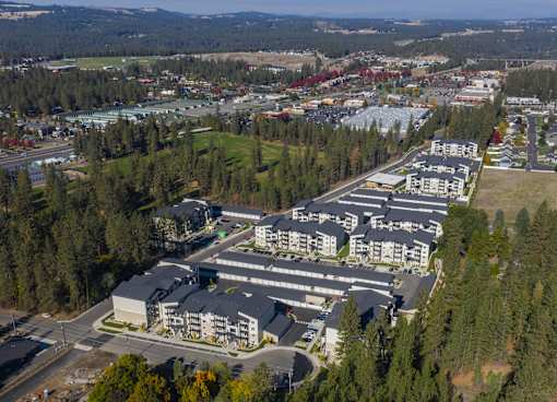 A large building complex surrounded by trees.