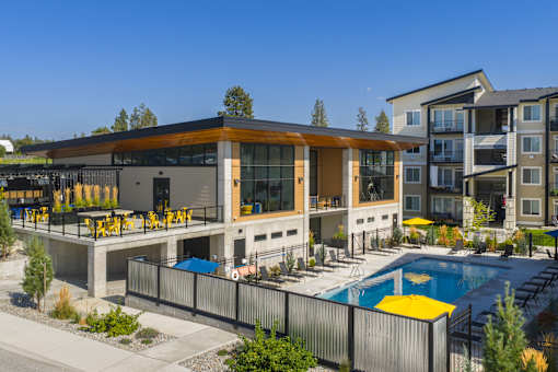 A modern building with a pool in front.