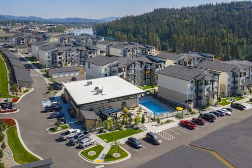 A large building with a pool in front of it.