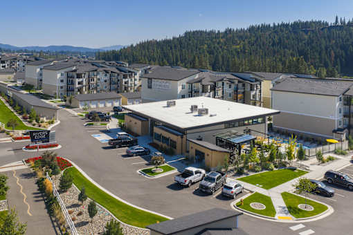 A parking lot in front of a building with a sign that says "CHAMBER".