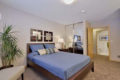 a bedroom with a large bed and a mirror