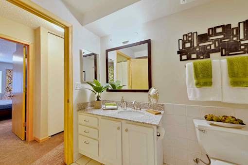 A bathroom with a white sink and a white toilet.