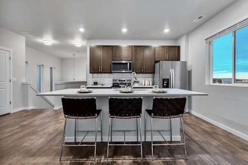 A modern kitchen with a dining table and chairs.