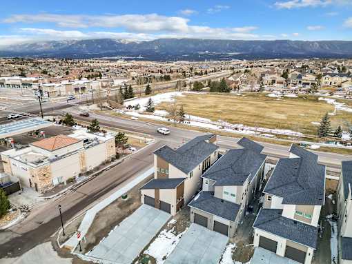 A view of a town with houses and buildings from a high vantage point.