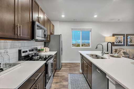 A modern kitchen with stainless steel appliances and wooden cabinets.