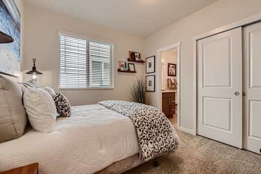 a bedroom with a bed and a door to a bathroom