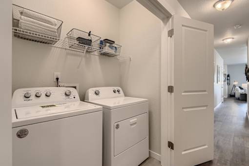 a washer and dryer in a laundry room with a door to a room