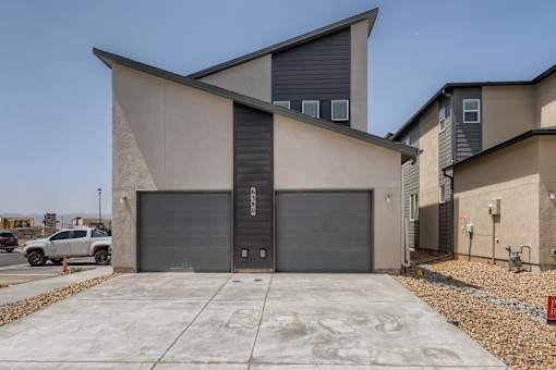 the front of a building with two garage doors