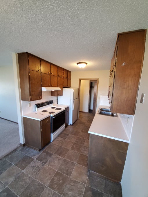 a view of the kitchen from the top of the stairs