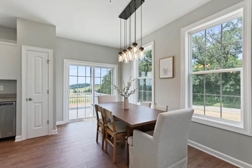 a dining room with a table and chairs at Fields of Aberdeen Apartments, Aberdeen, MD