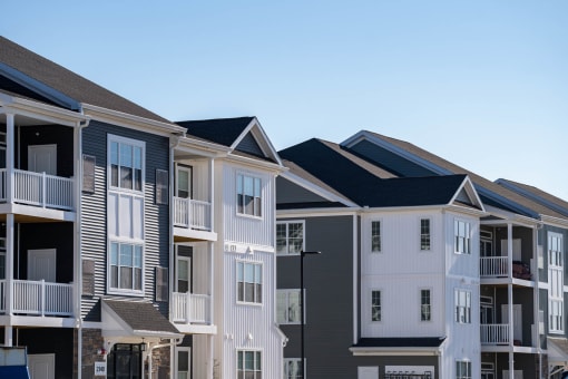 a row of townhomes with black roofs