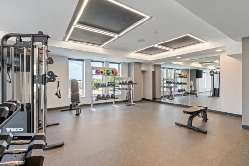 a large fitness room with treadmills and other exercise equipment
