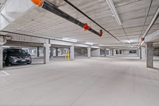 an empty parking garage with a car parked in it