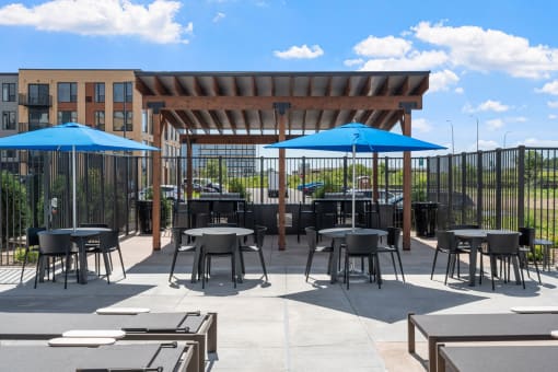 an outdoor patio with tables and umbrellas
