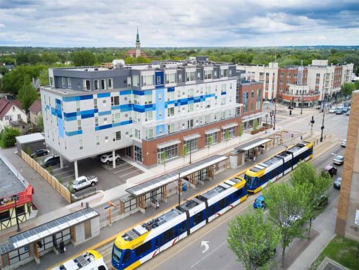 an aerial view of a train station with a train on the tracks