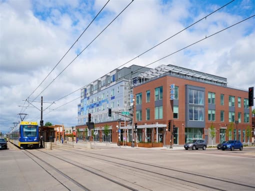 a street scene with a train and a building