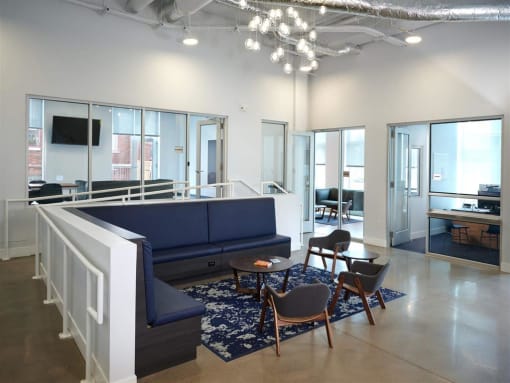 a large room with a blue couch and chairs