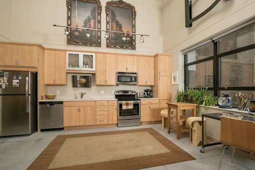 a kitchen with wooden cabinets and stainless steel appliances