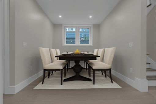 a dining room with a table and chairs