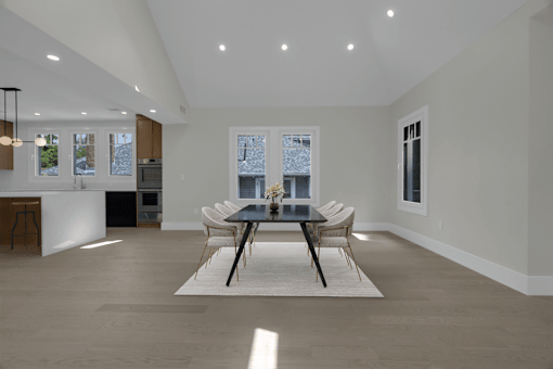 a dining room with a table and chairs and a kitchen