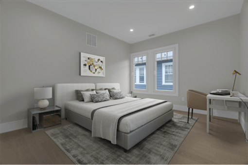 a bedroom with a bed and a desk with a chair