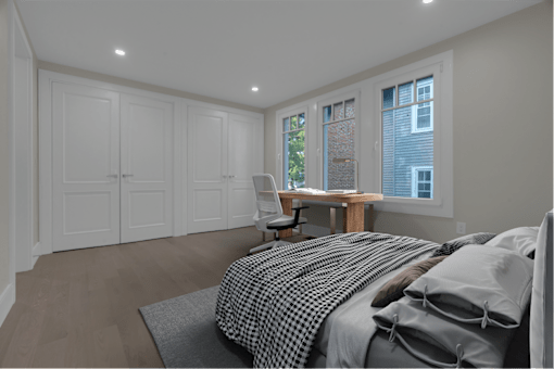 a bedroom with a bed and a desk with a chair