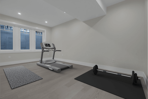 a gym with a reformer and yoga mats in a room with white walls