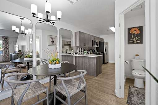 a living room and kitchen with a table and chairs