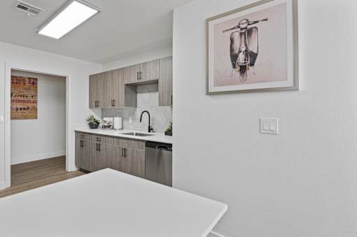 an apartment kitchen and dining room with a white table