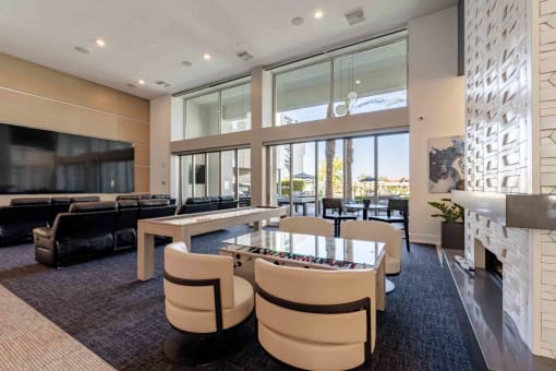 a game room with a foosball table and chairs