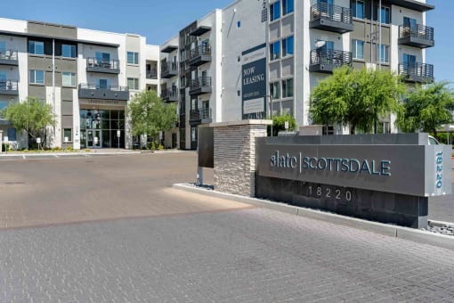 a view of the main entrance to slate scottsdale apartments in the background