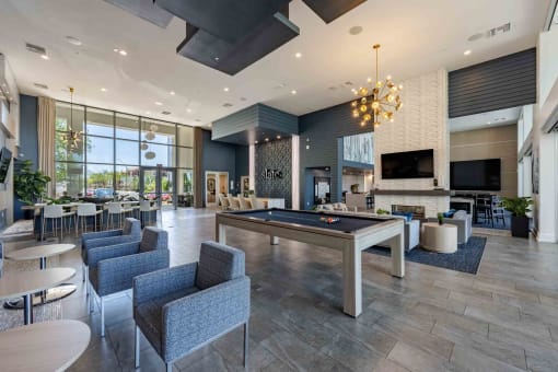 a spacious lobby with a pool table and lounge area