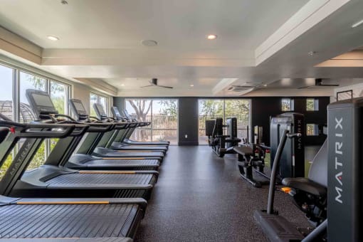 a row of treadmills and exercise machines in a fitness room at slate scottsdale