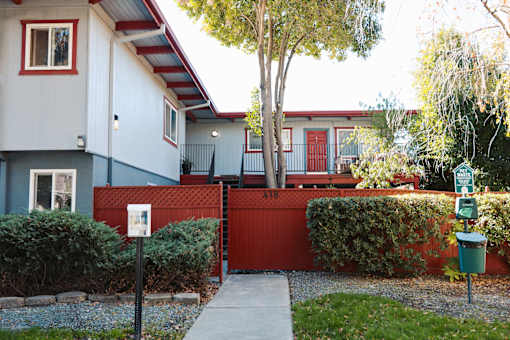 A house with a red fence and a mailbox at I Street Apartments, Davis, 95616
