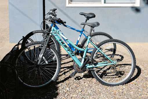 A blue bicycle is leaning against a wall at I Street Apartments, Davis, California