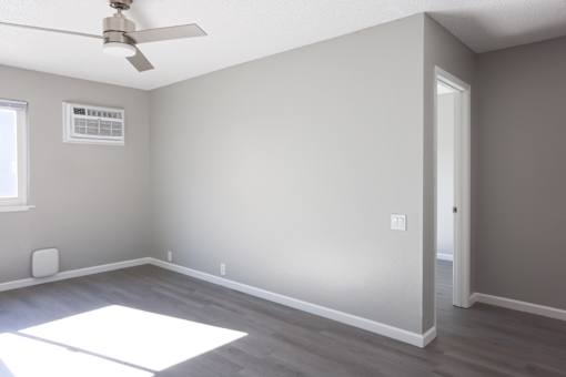 A room with a ceiling fan and a window.
