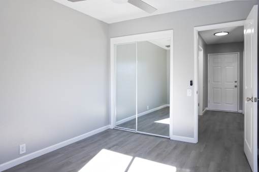 A room with a white door and a white mat on the floor.