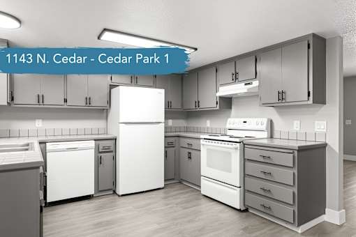 A modern kitchen with a white refrigerator, white oven, and white cabinets.