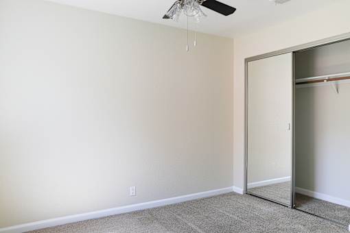 an empty room with a closet and a ceiling fan at Creekview Homes, Chico, CA, 95928
