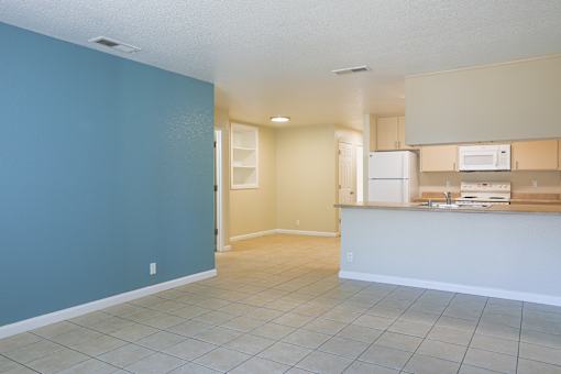 an empty kitchen and living room with a blue wall at Creekview Homes, Chico