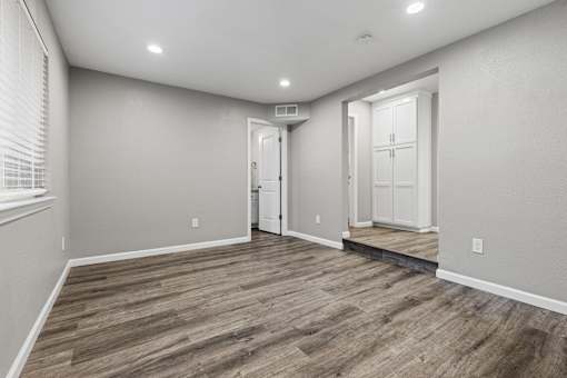 A room with a wooden floor and white walls.at OSM Properties Homes & Apartments, California, 95926
