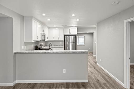 A kitchen with a counter and cabinets.at OSM Properties Homes & Apartments, California  