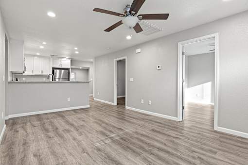 A spacious room with a ceiling fan and lighting fixtures.at OSM Properties Homes & Apartments, California, 95926