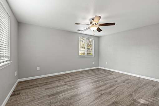 A room with a ceiling fan and a window with blinds.at OSM Properties Homes & Apartments, Chico California  