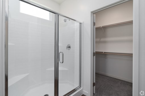 a bathroom with a shower and a sink in it