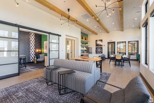 A modern living room with a grey sofa and a black coffee table.
