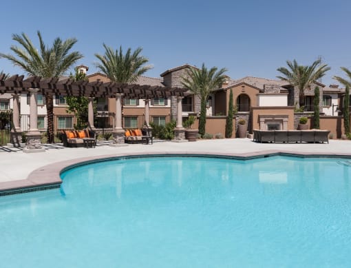 a swimming pool at the community with palm trees