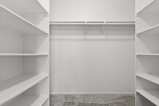 Empty white shelves in a room.