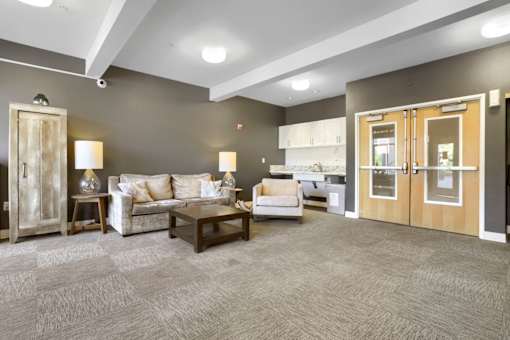 A living room with a couch, armchair, and coffee table.